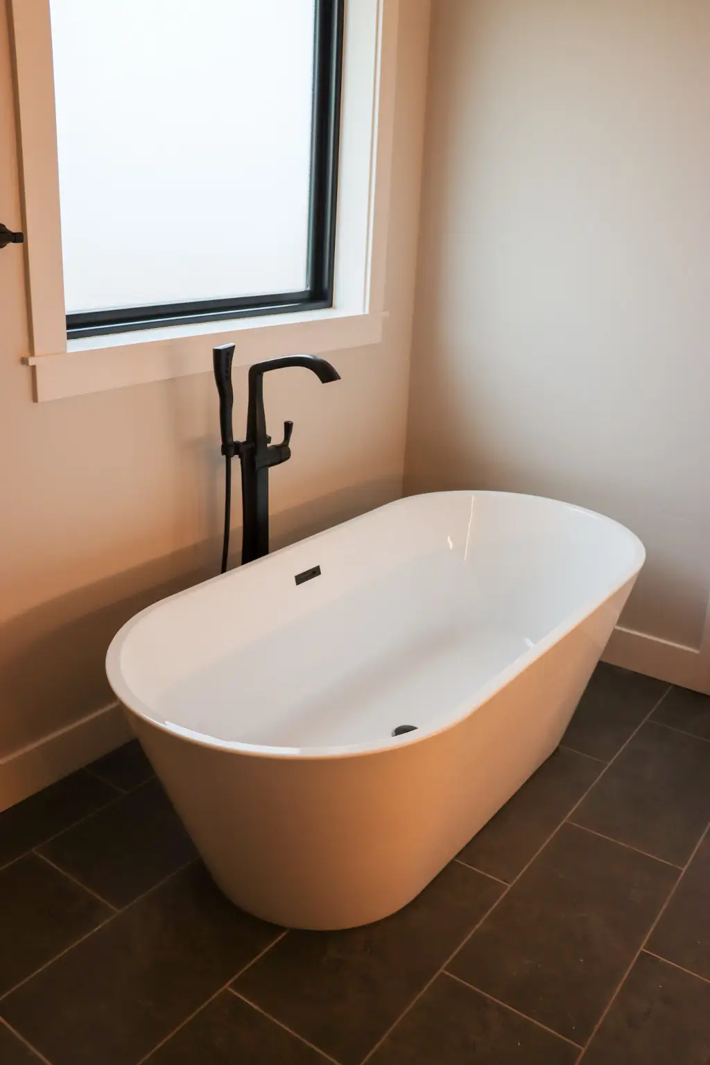 Freestanding soaking tub in primary suite