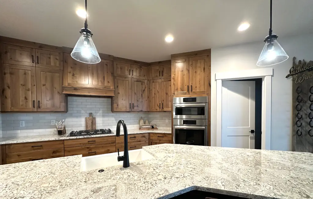 Kitchen — slab-to-ceiling cabinetry and island