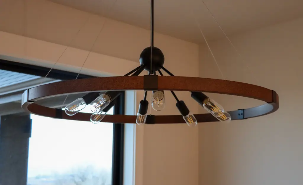 Wrought-iron chandelier from log ceiling